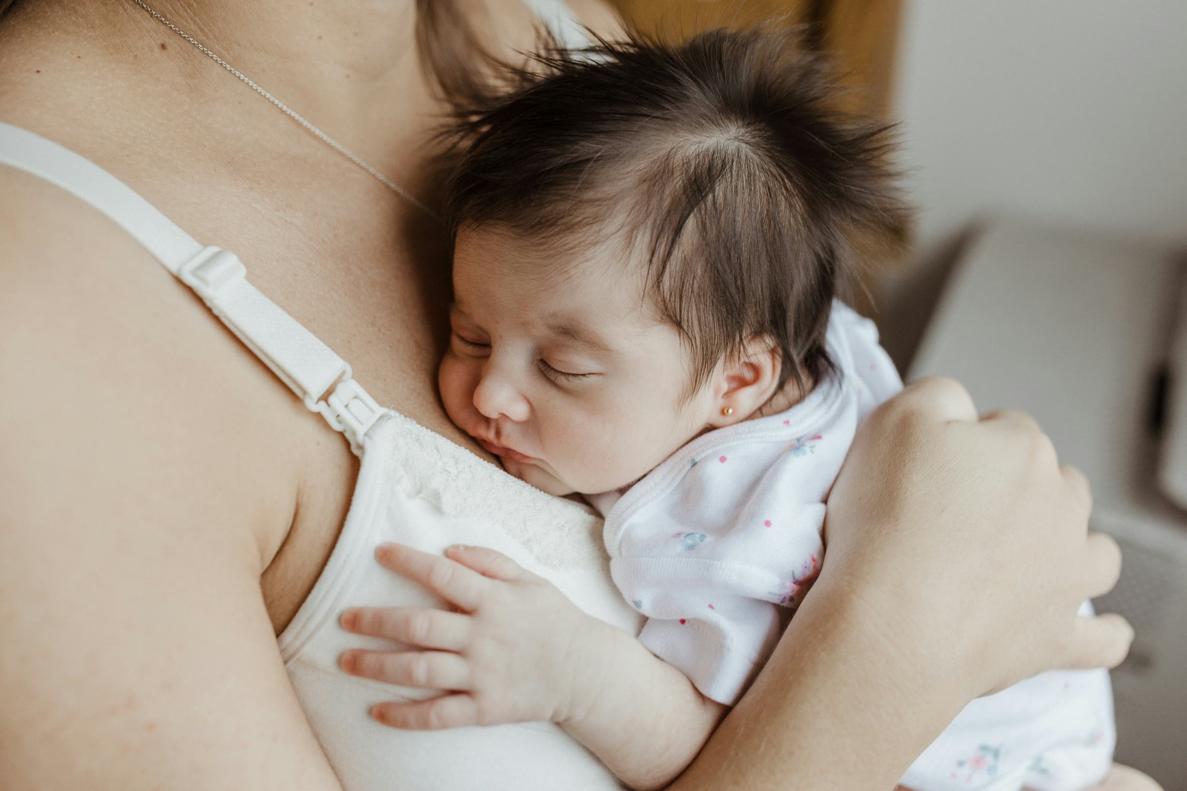 A newborn asleep on her mother's chest